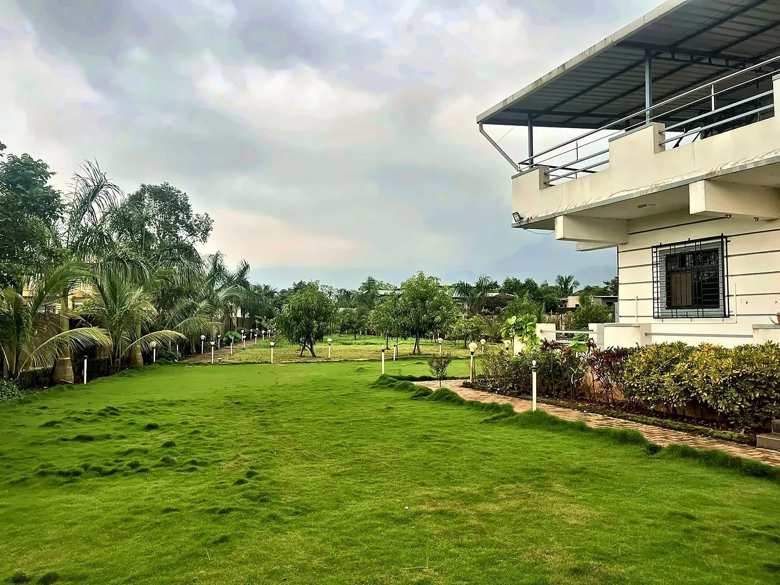 Lawn and house, Aamantara Villa, Karjat